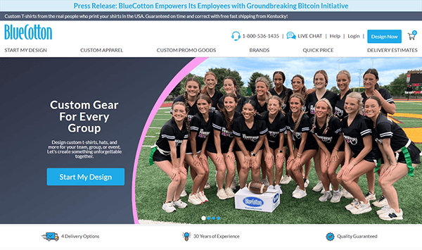 A group of cheerleaders poses on a football field with a custom BlueCotton box, featured on the BlueCotton website homepage to showcase the best T-shirt design for custom apparel.