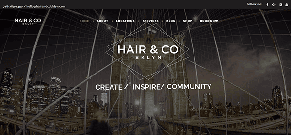 Screenshot of the Hair & Co BKLYN website homepage featuring a nighttime Brooklyn Bridge background, navigation menu, and the tagline "Create / Inspire / Community"—a standout example among the best salon websites.