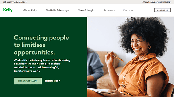 Smiling woman with curly hair sits on a couch holding a pencil and notebook. Text on the screen promotes career opportunities with Kelly, highlighting connection, job search support, and why Kelly is among the top recruiting sites.