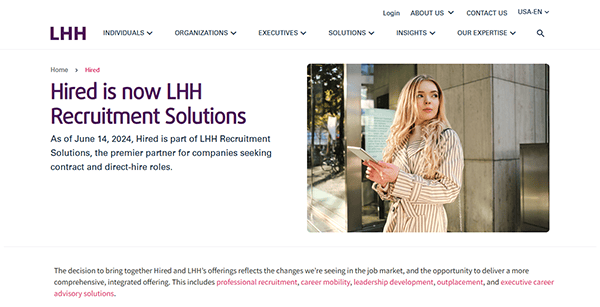 Screenshot of a website announcement stating, "Hired is now LHH Recruitment Solutions," with a photo of a woman holding a laptop outdoors—highlighting one of the best recruiting websites evolving in the industry.