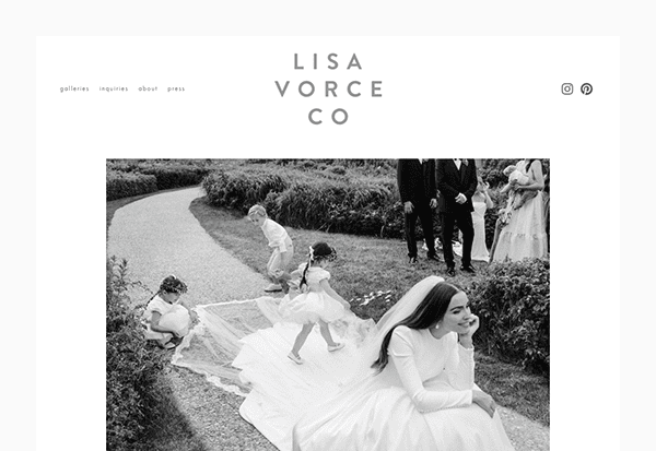 A bride in a long gown sits outdoors on a path, smiling, as children play with her train; several adults and another child stand nearby, capturing the joy of expert wedding planning.