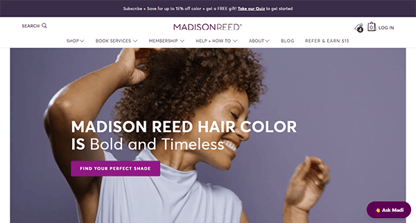 Homepage of Madison Reed featuring a woman with curly hair posing joyfully, plus navigation menu and a headline promoting bold and timeless hair color—an inspiration for the best salon websites.