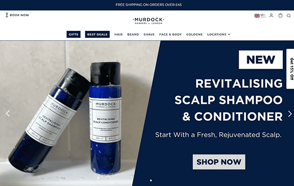 Two blue bottles of Murdock London Revitalising Scalp Shampoo and Conditioner are displayed beside a website banner, inspired by top salon websites, promoting the products with a "Shop Now" button.