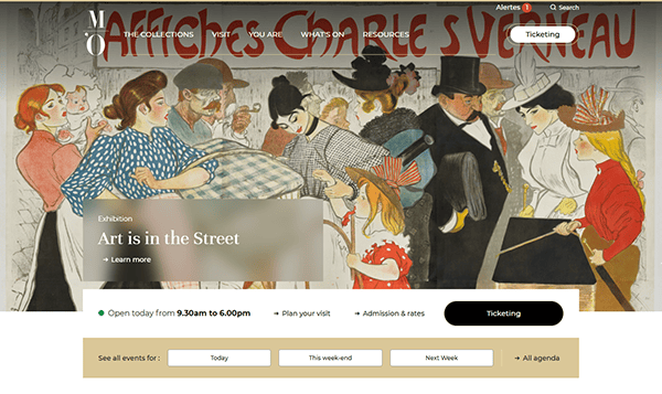 A museum website homepage features a vintage street art painting as the background, showcasing exhibition details and a navigation menu. This creative museum website design highlights modern trends in digital curation.
