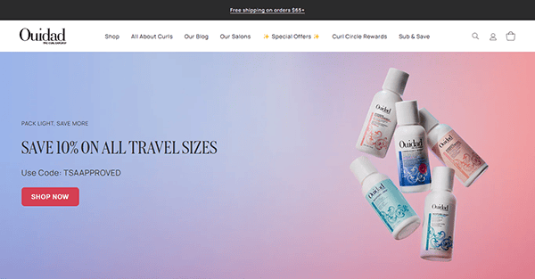 Ouidad's salon website design features a banner offering 10% off all travel-size hair products with code TSAAPPROVED. Six small bottles are displayed on a pastel gradient background, showcasing why it's among the best salon websites.