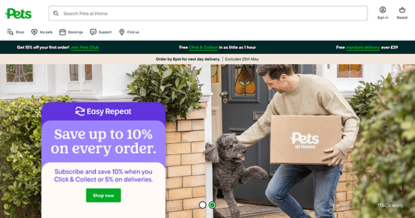 A man holding a Pets at Home box greets a large grey dog at the front door, showcasing why Pet Shop Websites highlight discounts and delivery offers on their banners.