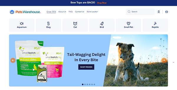 Screenshot of the Pets Warehouse website homepage, a standout among pet shop websites, featuring navigation links, pet categories, food products, and a dog in a field beside the tagline "Tail-Wagging Delight In Every Bite.