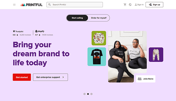 Printful homepage featuring the slogan “Bring your dream brand to life today,” showcasing top T-Shirt Design Websites, product images, two seated women in branded apparel, and buttons for getting started or enterprise support.