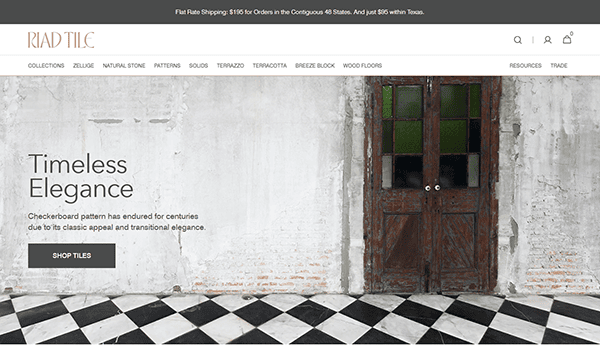 Riad Tile website homepage showcasing stunning tile design—a checkered tile floor, weathered white wall, double doors, and the text “Timeless Elegance” with a call-to-action button to shop tiles. Discover one of the best tile websites today.