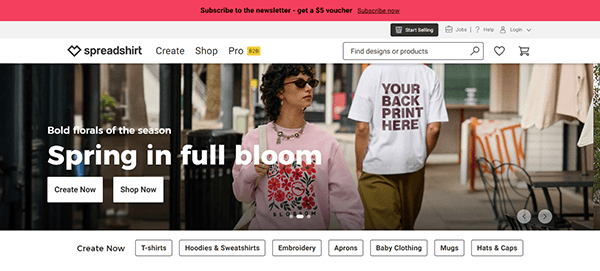 Spreadshirt homepage featuring a woman in a floral sweatshirt and a person in a “YOUR BACK PRINT HERE” shirt, showcasing one of the best T-Shirt design websites with easy navigation and product category links.