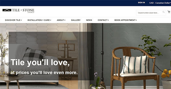 Website homepage for Tile and Stone Source, featuring a modern living room with decorative wall tiles, a lamp, an armchair, and the slogan "Tile you'll love, at prices you'll love even more"—your go-to spot for tile inspiration from one of the best tile websites.