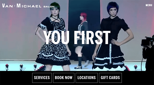 Two models in black dresses pose on a runway with "YOU FIRST" text overlay; striking salon website design and menu options appear on screen.
