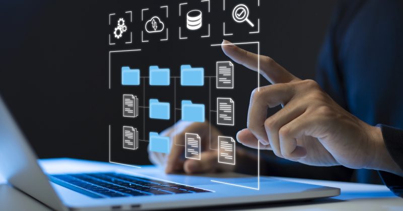 A person uses a laptop with a virtual interface displaying secure digital folders, documents, and technology-related icons, managing digital downloads and WordPress plugins seamlessly.