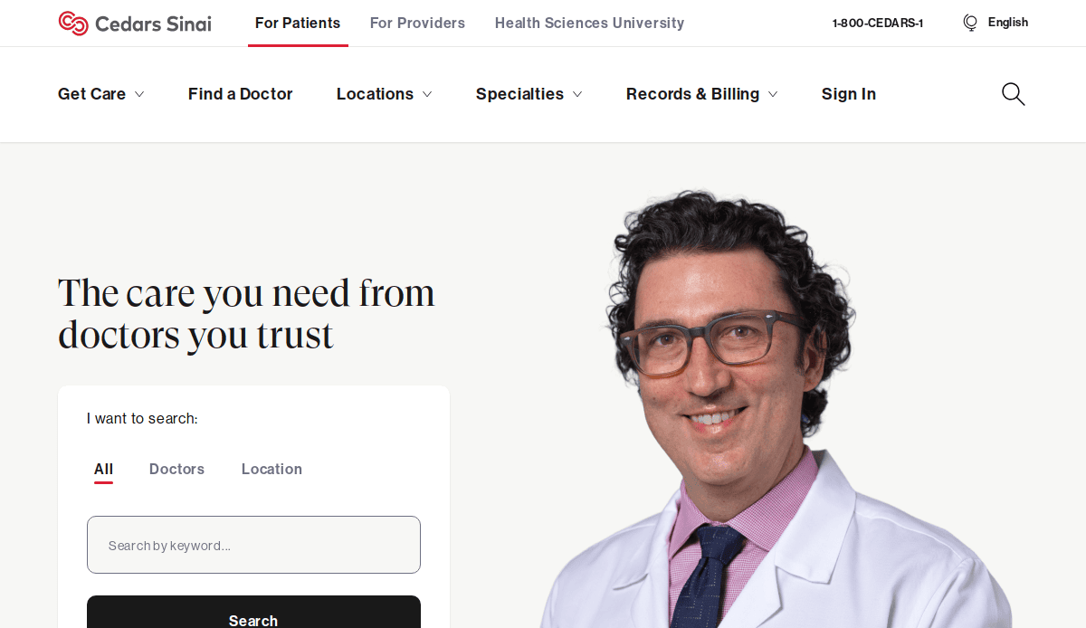 A smiling male doctor in a white coat and glasses appears on the Cedars-Sinai website, showcasing thoughtful Healthcare website design with navigation menus and a search box to enhance patient trust when finding doctors or locations.