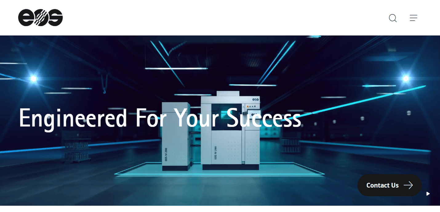 Futuristic room with two large EOS machines on a glowing platform; text overlay reads Engineered For Your Success, showcasing our expertise in manufacturing website design, with a Contact Us button on the right.