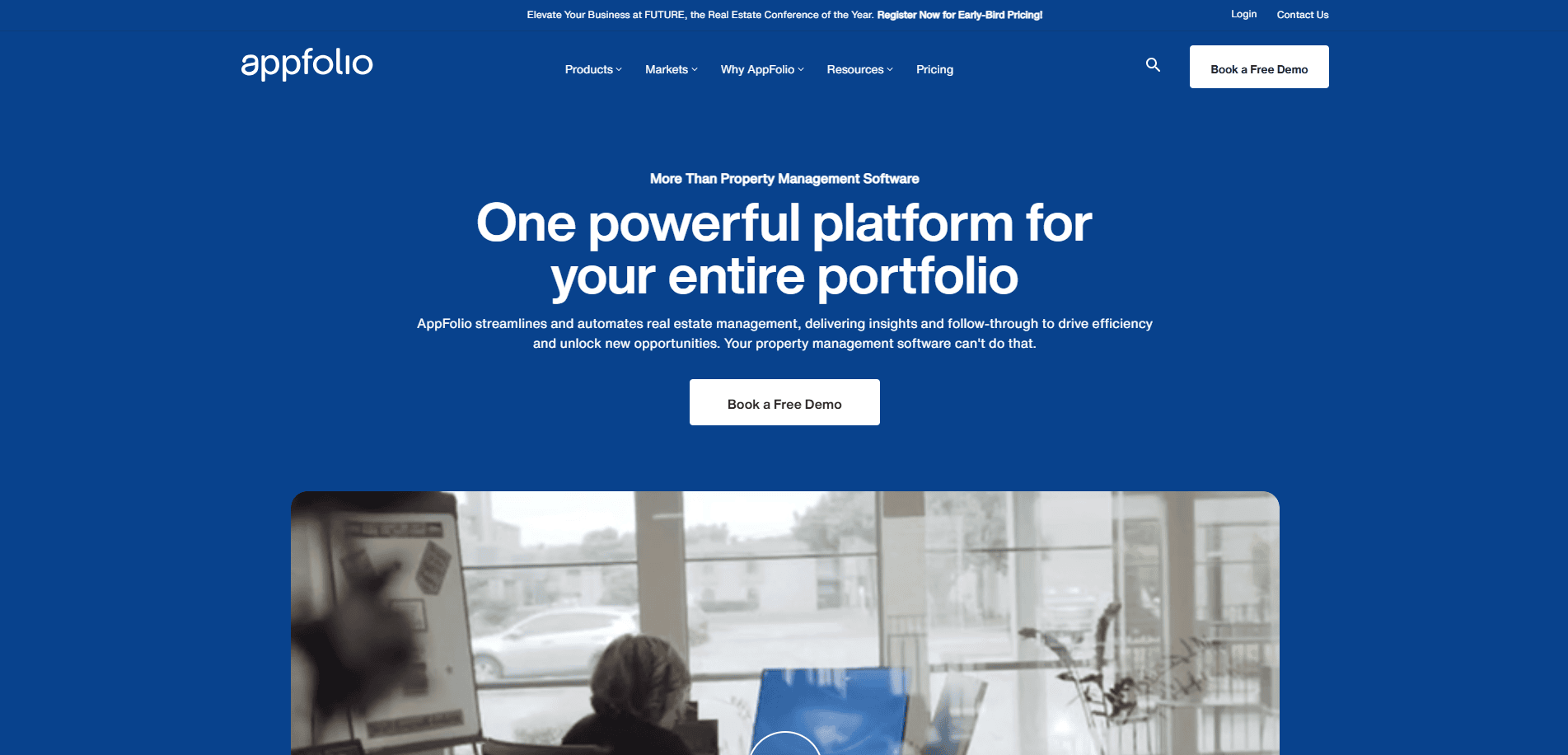 Screenshot of the Appfolio property management website homepage, featuring a blue banner with white text promoting property management software, a “Book a Free Demo” button, and a video thumbnail below showing people in an office.