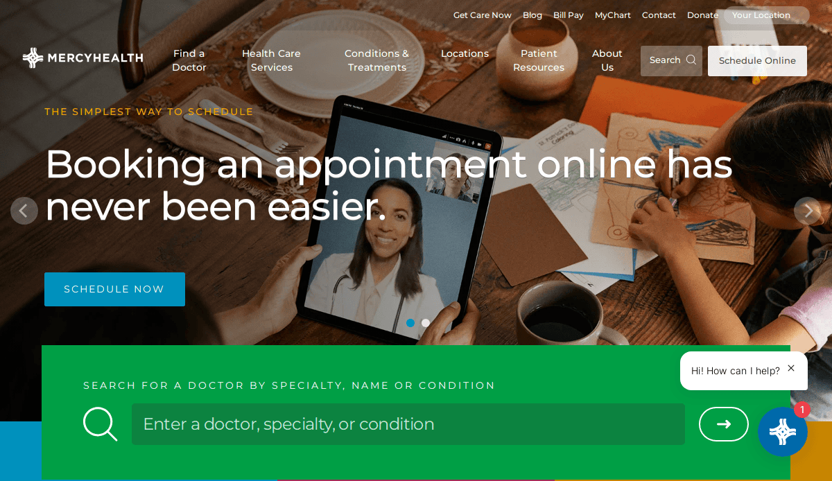 A person holds a smartphone displaying a video call with a doctor. Text reads, Booking an appointment has never been easier. The website navigation and doctor search bar highlight thoughtful healthcare website design.