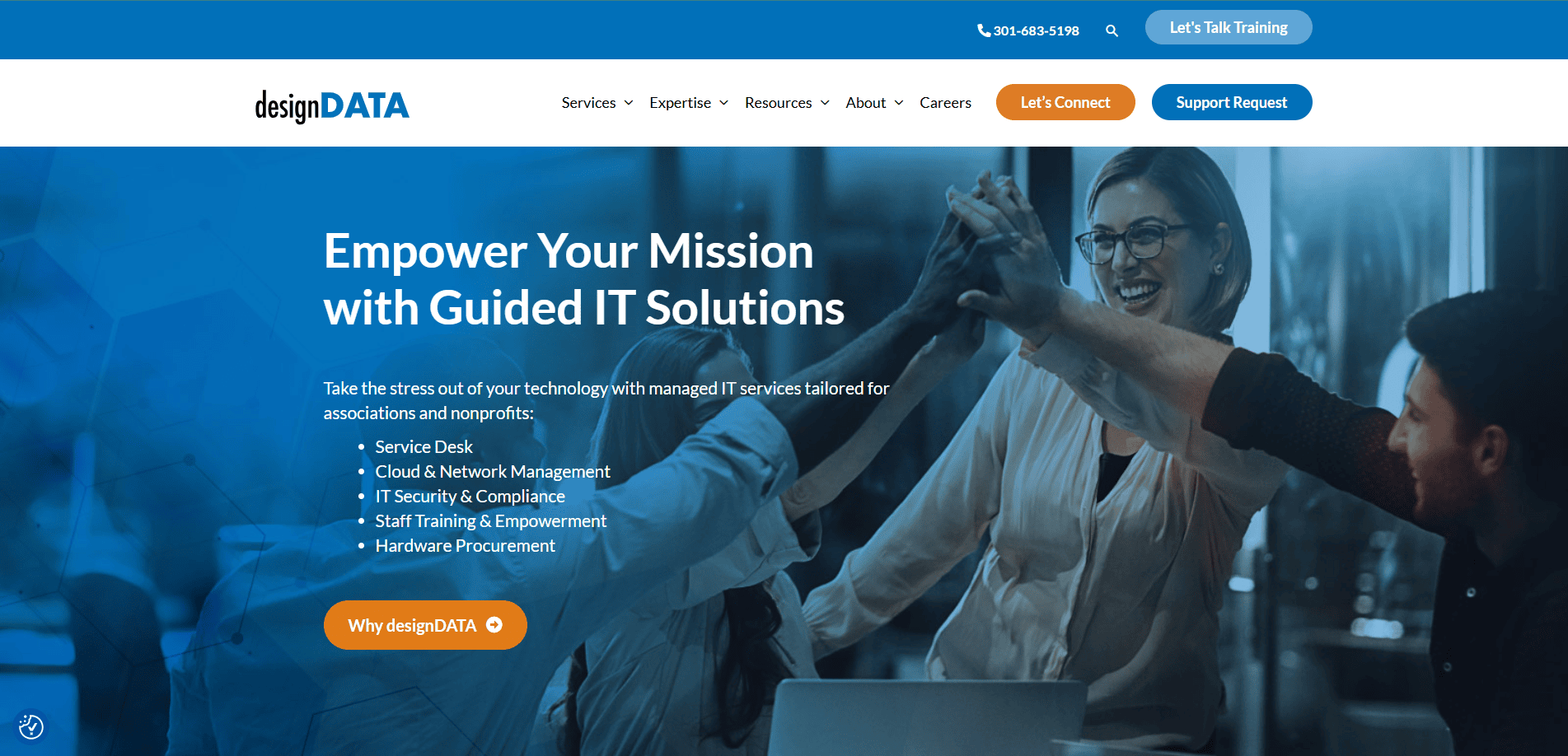 Screenshot of designDATA’s MSP website homepage showing a blue-tinted banner with the text Empower Your Mission with Guided IT Solutions and a group of people high-fiving at a desk. Navigation and contact buttons appear at the top.