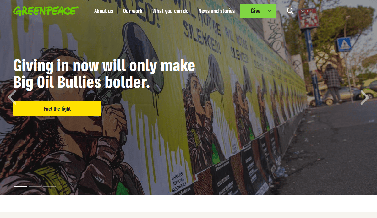 A line of posters showing a person shouting into a megaphone covers a wall; text on the image reads, Giving in now will only make Big Oil Bullies bolder. An eye-catching yellow Fuel the fight button below draws Environmental Web Design inspiration.