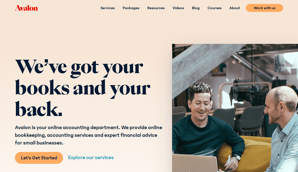 Two men sit at a table with laptops, smiling and discussing work in a modern office. The text on the left promotes high-performance online bookkeeping and accounting services for small businesses on your CPA website.