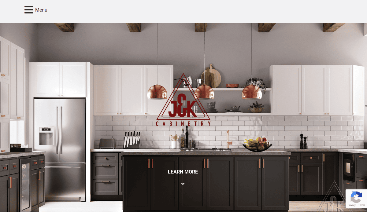 Modern kitchen with white upper cabinets, dark lower cabinets, stainless steel appliances, copper pendant lights, and decorative items on open shelves. Perfect for your kitchen portfolio. The J&K Cabinetry logo is centered on the image.