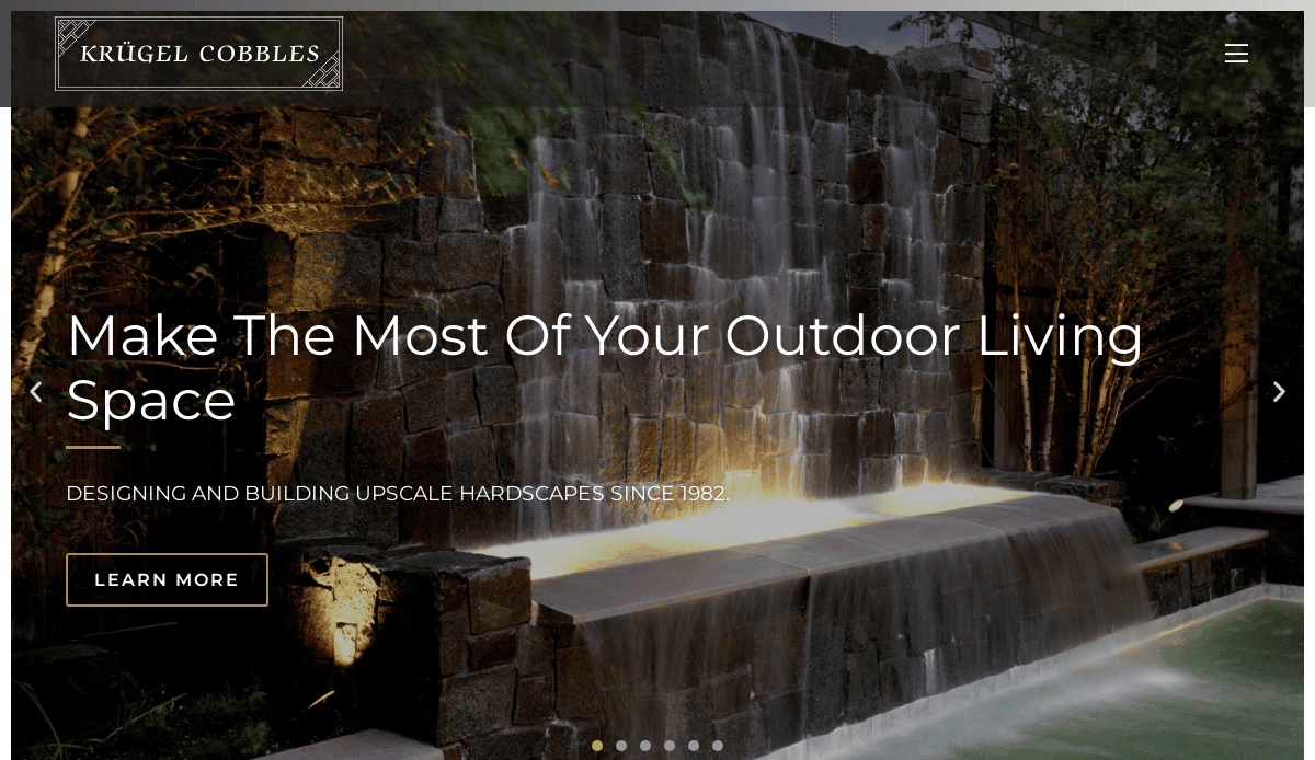 A modern stone water feature with cascading waterfalls and soft evening lighting, overlaid with the Krügel Cobbles logo and text promoting upscale outdoor living space design for your fence service website.