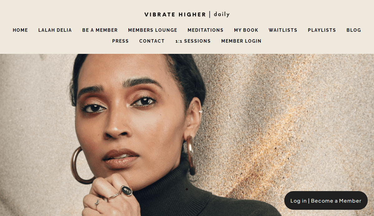 A woman with hoop earrings and a turtleneck sweater rests her chin on her hand, looking thoughtfully at the camera. The life coach website menu and Vibrate Higher Daily are visible at the top, hinting at tips for fixing or losing clients.
