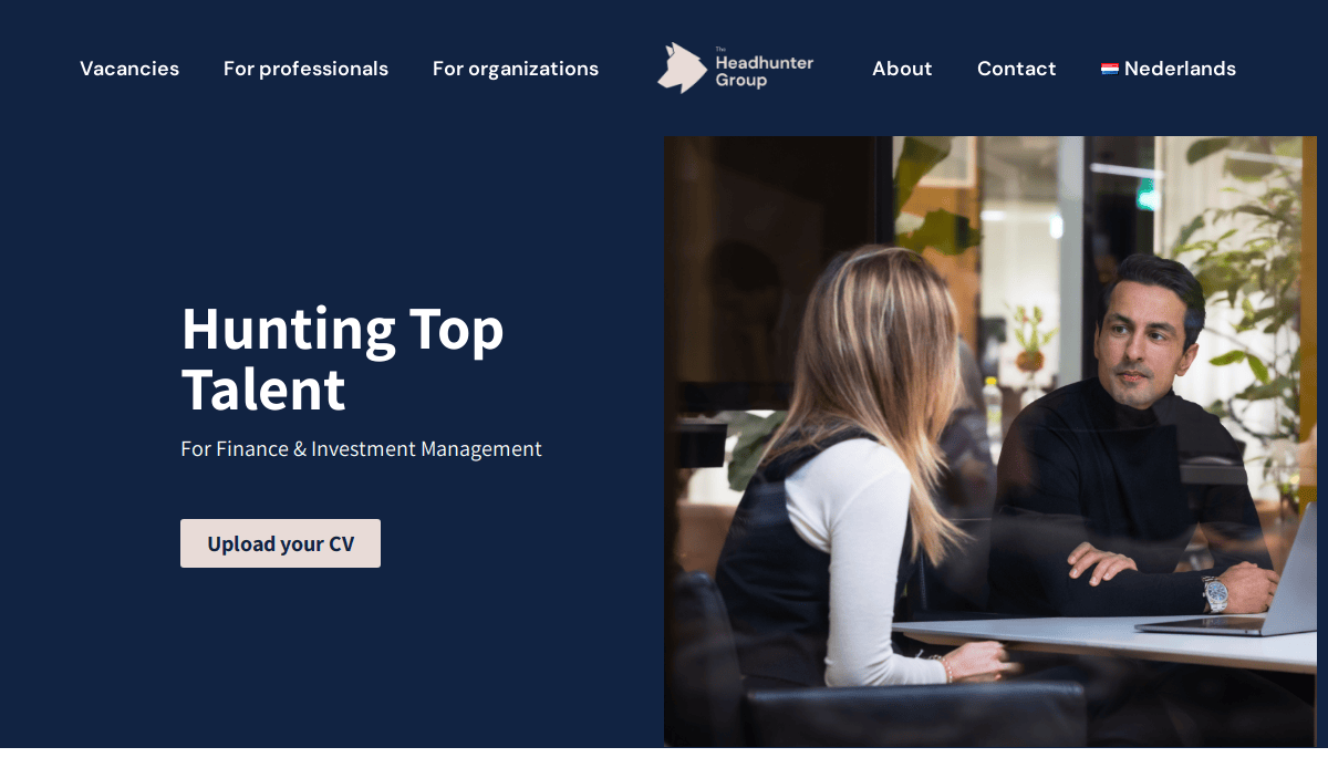 A woman and a man sit across from each other at a desk in a modern office. The website headline reads Hunting Top Talent, highlighting this recruitment agency’s expert guide to success, with a button below to upload your CV and easy navigation links at the top.
