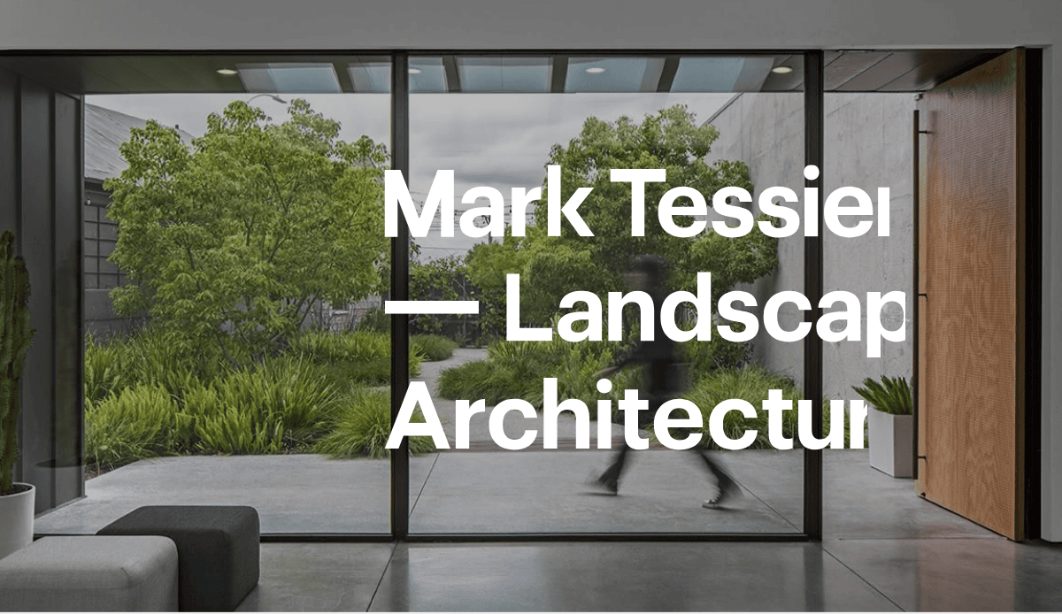 A person walks past large glass doors in a modern building, with lush green landscaping visible outside. Bold white text reads: Mark Tessier — Landscaping Services & Landscape Architecture.