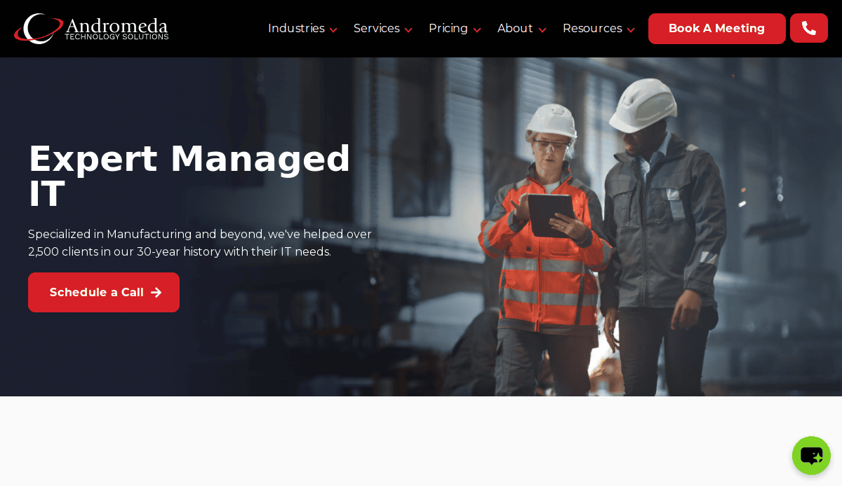 Two workers in safety gear review information on a tablet in an industrial setting. The website showcases Andromeda Technology Solutions’ expert managed IT services for manufacturing, highlighting effective MSP website design for industry leaders.