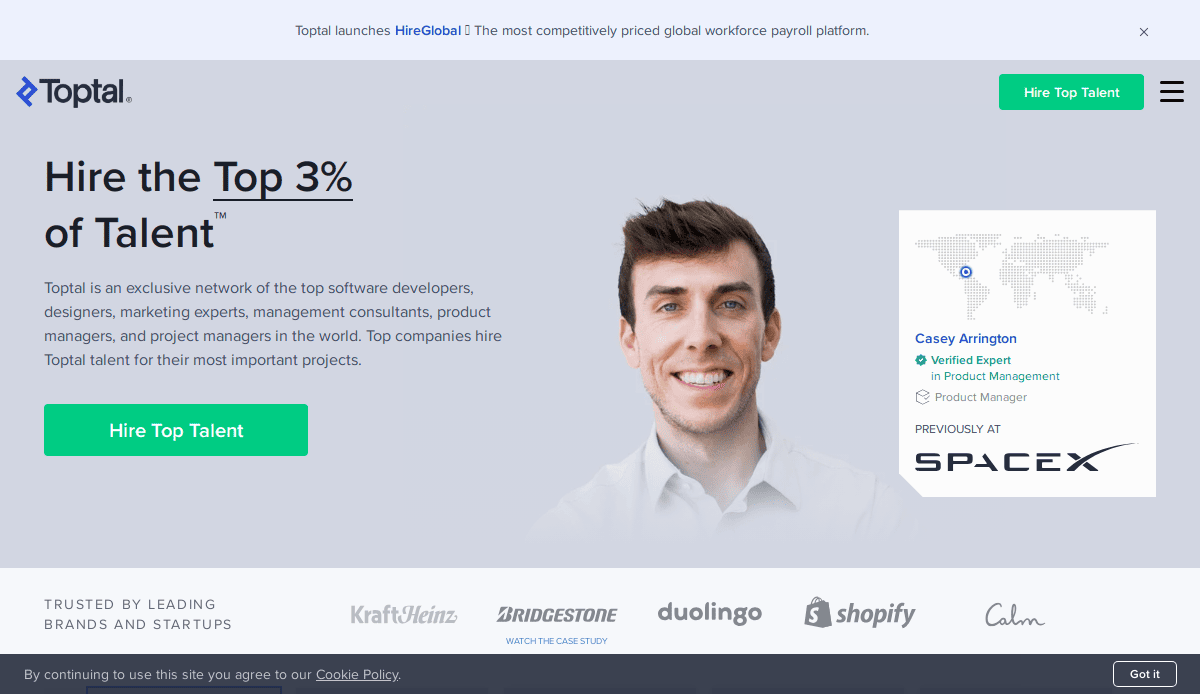 Homepage of Toptal featuring a smiling man in a white shirt, a “Hire the Top 3% of Talent” headline, a button to hire top talent, and logos of notable brands like SpaceX and Shopify—an ideal guide to exceptional website design and recruitment agency services.