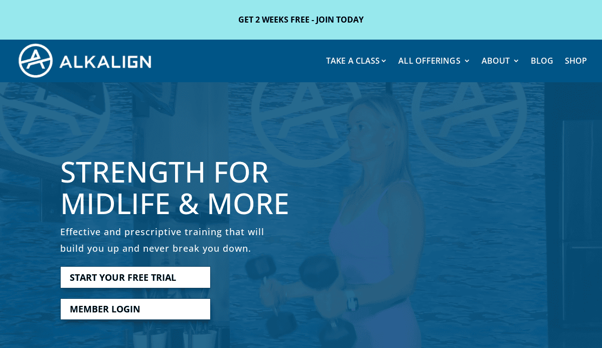 A woman in athletic wear lifts dumbbells in a fitness studio. Text reads “STRENGTH FOR MIDLIFE & MORE” with options to start a free trial or log in as a member. Alkalign branding appears at the top.