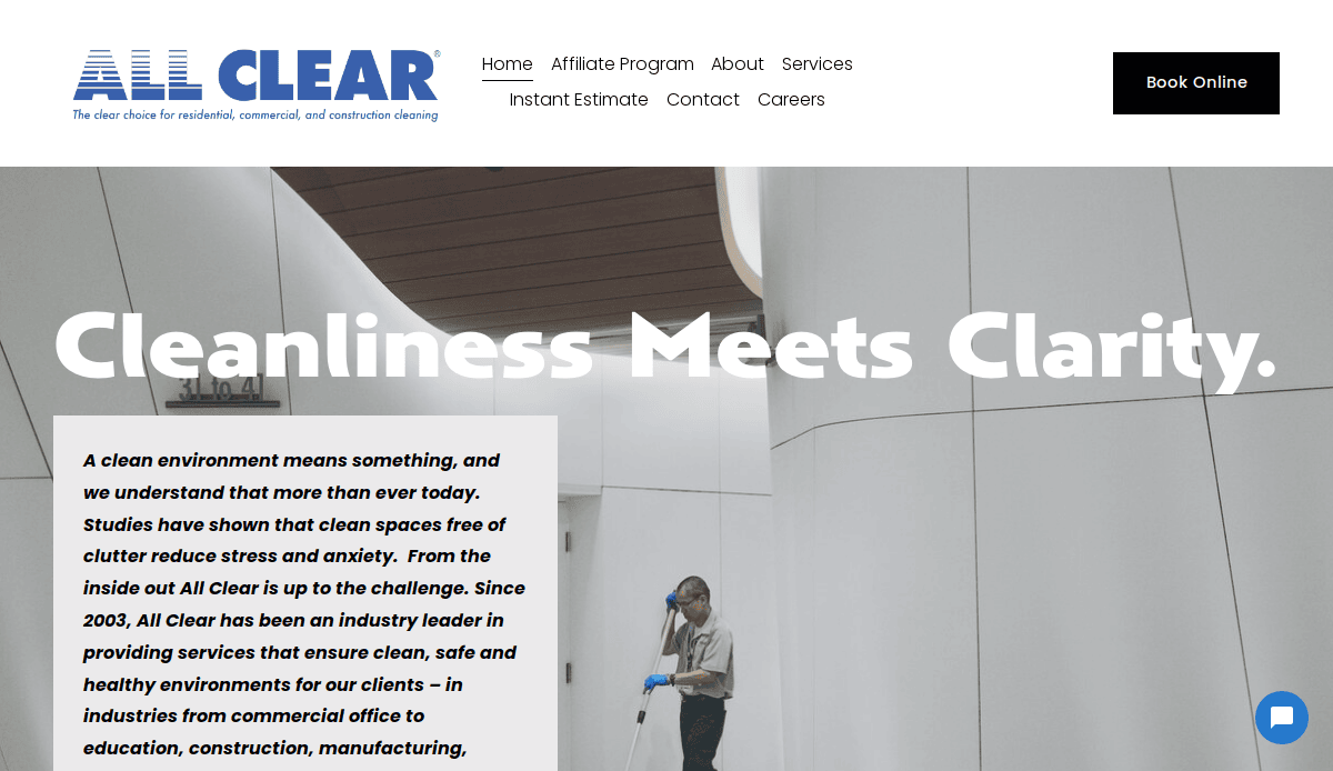 A person wearing cleaning attire uses equipment to clean the floor of a modern, white-walled building. The All Clear website banner and text promoting cleanliness appear at the top.