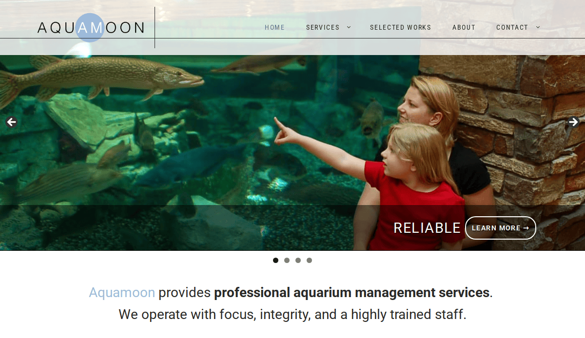 A woman and a young girl look at fish in a large aquarium; the girl points toward the fish. Text reads Aquamoon provides professional aquarium management services.