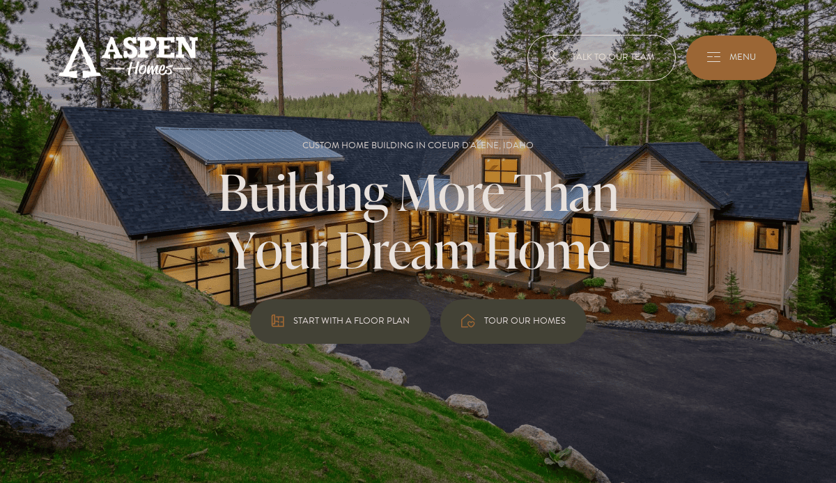 A modern house with large windows and warm lighting sits among tall pine trees at dusk. Text reads, Building More Than Your Dream Home. Aspen Homes logo and navigation buttons are visible.