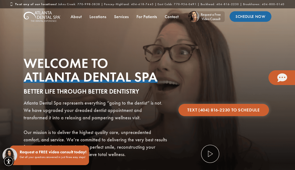 A woman with long brown hair and glasses smiles widely in a dental office setting. The screen displays welcome text for Atlanta Dental Spa with options to schedule, text, and request a free video consult.
