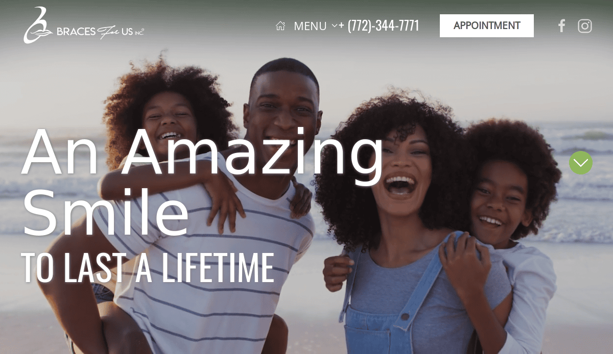 A smiling family of four, two adults and two children, stand closely together on a beach at sunset. The children are piggybacked on the adults, all appearing joyful and happy. Text reads: “An Amazing Smile To Last A Lifetime.”.