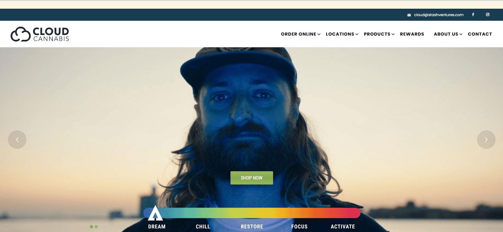 A man with long hair and a beard wearing a cap stands outside at sunset. The Cloud Cannabis website banner appears above, with menu options, a logo, and a Shop Now button over a colorful navigation bar.