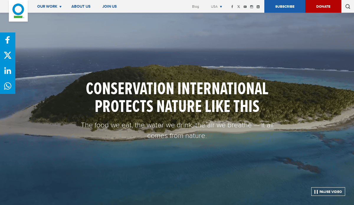 A lush green island surrounded by clear blue ocean with the text “Conservation International protects nature like this” overlayed, promoting nature conservation efforts.