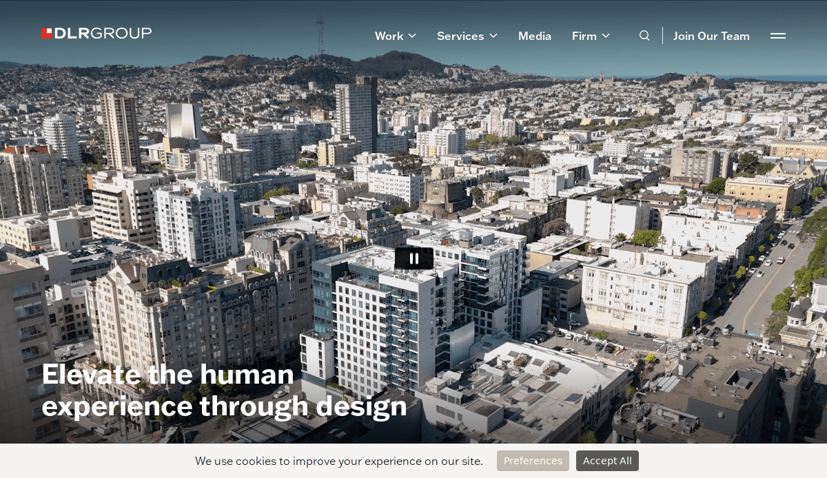 Aerial view of a cityscape with modern high-rise and mid-rise buildings; text overlay reads Elevate the human experience through design. The DLR Group logo and website navigation menu are visible at the top.