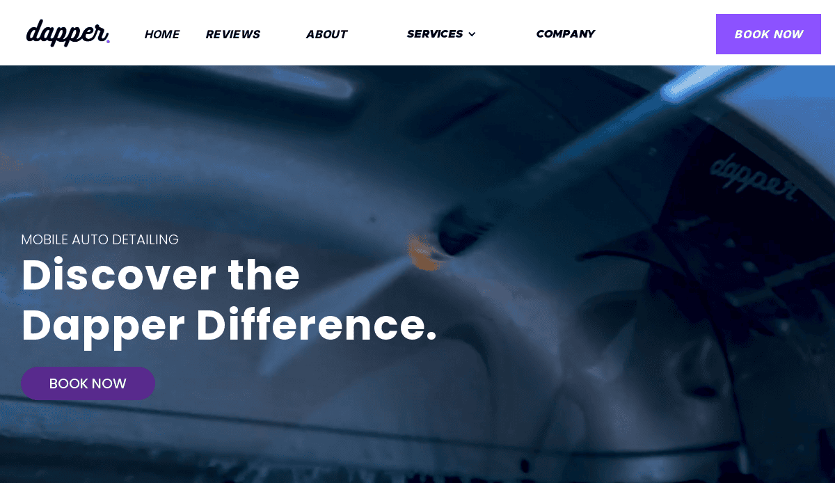 A car is being pressure washed with water; the text reads, Discover the Dapper Difference. Book Now. The Dapper logo and website menu are visible at the top of the page.