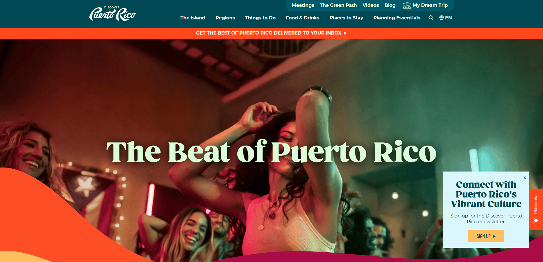 A group of people dance joyfully under colorful lights. Text reads “The Beat of Puerto Rico.” A sign-up box invites visitors to connect with Puerto Rico’s vibrant culture. The Discover Puerto Rico website menu is visible at the top.