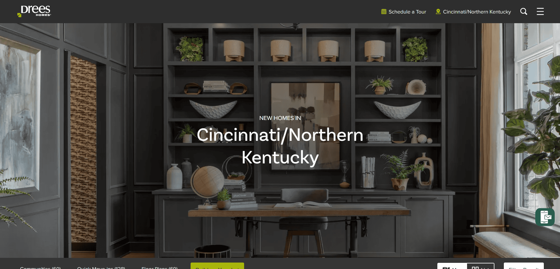 A stylish home office with built-in dark shelves, decor items, green plants, a desk and chair, and a large window. Text overlay reads: New homes in Cincinnati/Northern Kentucky.