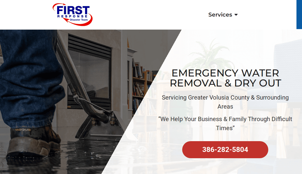 A person uses a wet vacuum to remove water from a flooded living room with furniture. Text reads, EMERGENCY WATER REMOVAL & DRY OUT, and displays a contact number, company logo, and service areas.