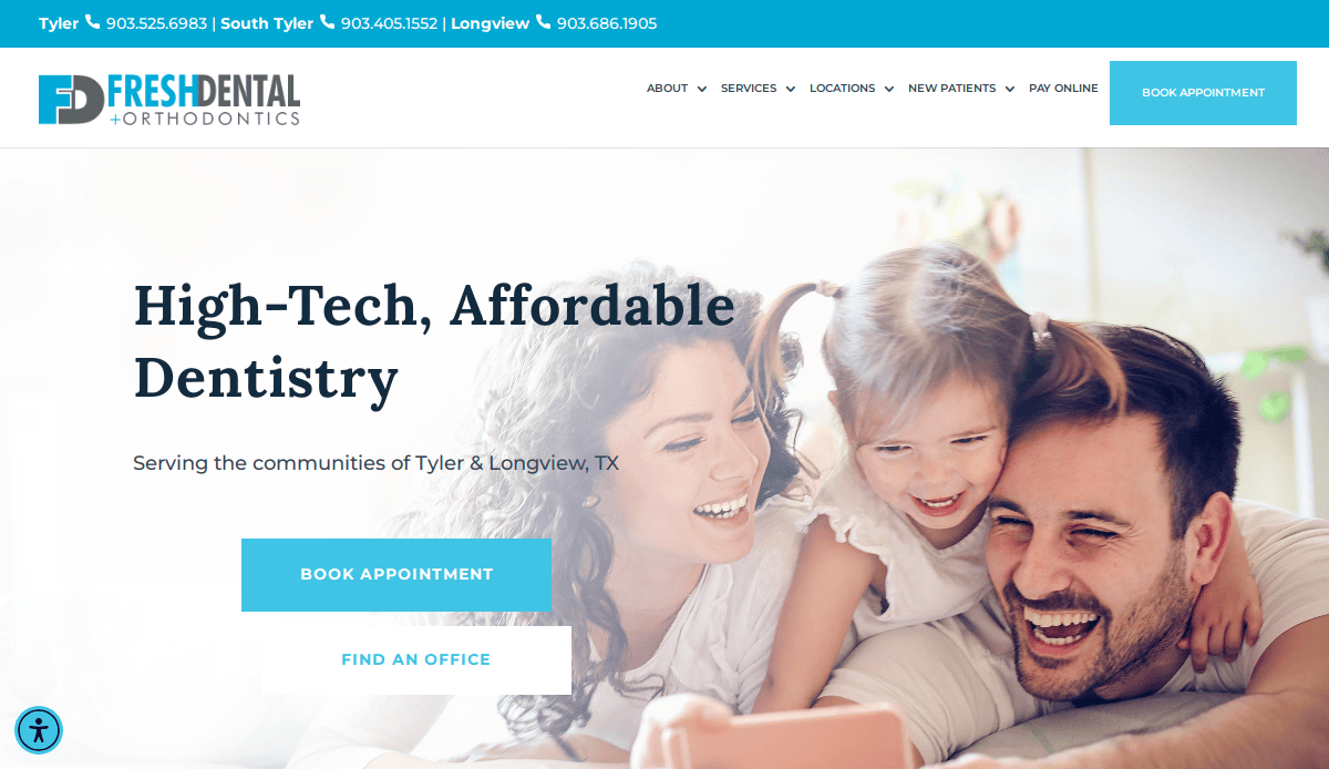 A smiling family of three, including a man, woman, and young girl, lay on a bed together using a tablet. The Fresh Dental Orthodontics website promotes high-tech, affordable dentistry with options to book appointments.