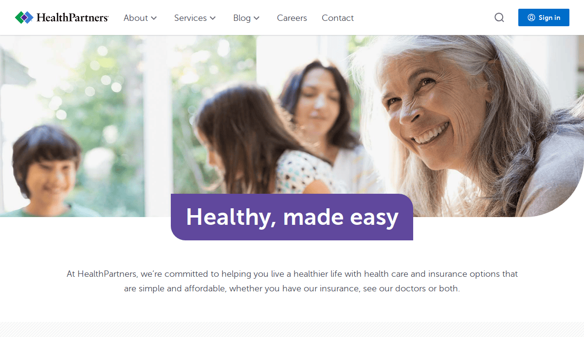 A smiling older woman sits outdoors with a group of people in the background. Overlaid text reads, Healthy, made easy. The image is from the HealthPartners website.