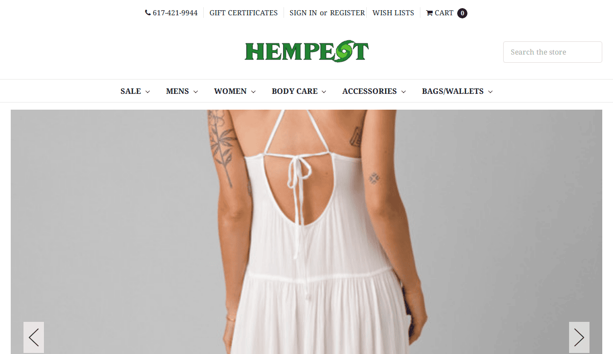 A person wearing a white, backless, halter-neck dress with thin straps is shown from behind, displaying tattoos on both arms. The image is on a website called Hempest.