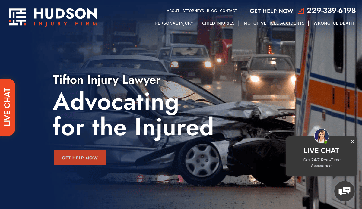 A car crash scene with damaged vehicles and emergency responders, overlaid with text for Hudson Injury Firm, advertising legal help for injury cases and a live chat option.