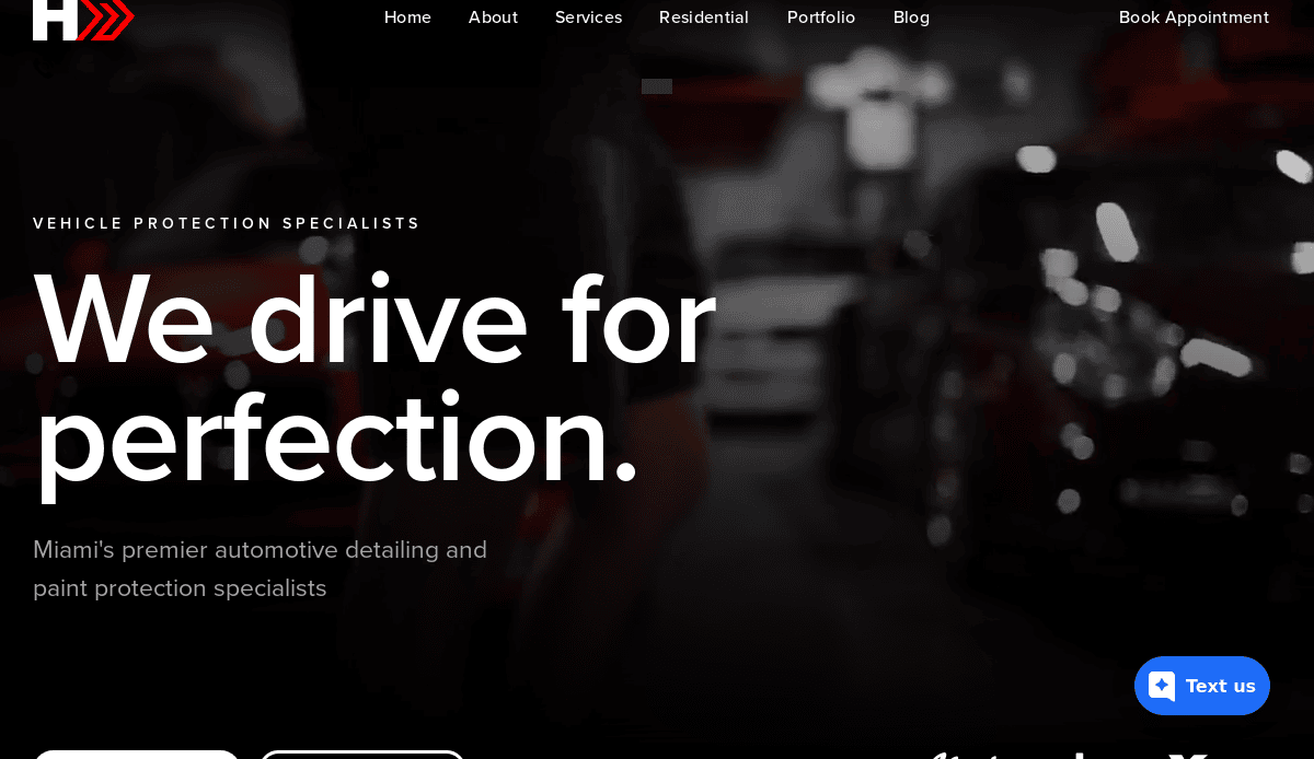 Website homepage for a Miami automotive detailing business, featuring the text We drive for perfection and blurred images of cars in the background. Navigation links and a blue Text us button are visible.