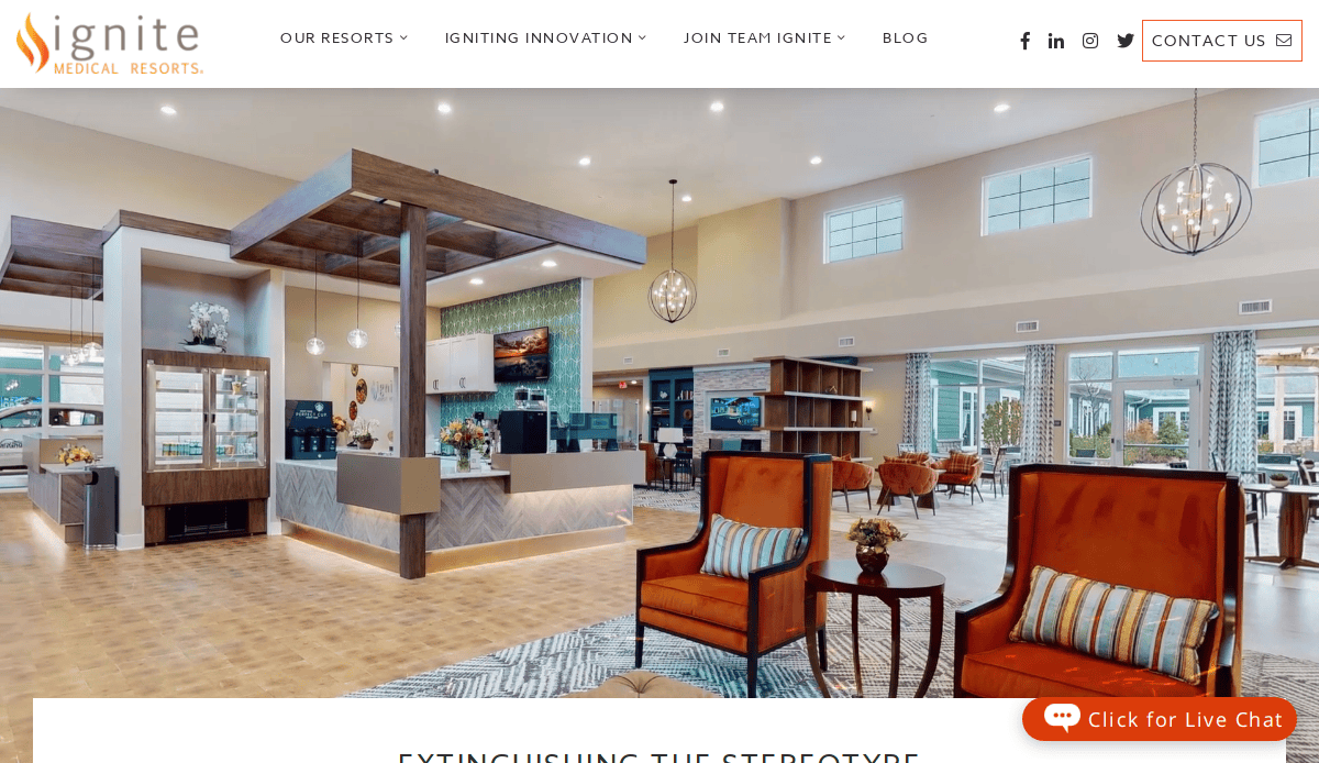 A spacious, modern hotel lobby with high ceilings, large windows, stylish seating, and a central reception desk. Warm lighting and contemporary decor create a welcoming atmosphere at Ignite Medical Resorts.